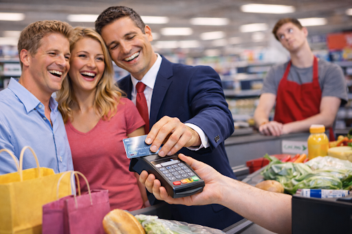 Local family tapping credit card at the Thomas Flat supermarket
